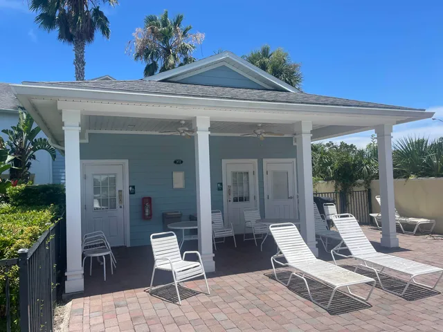 a view of a patio with a table and chairs and potted plants