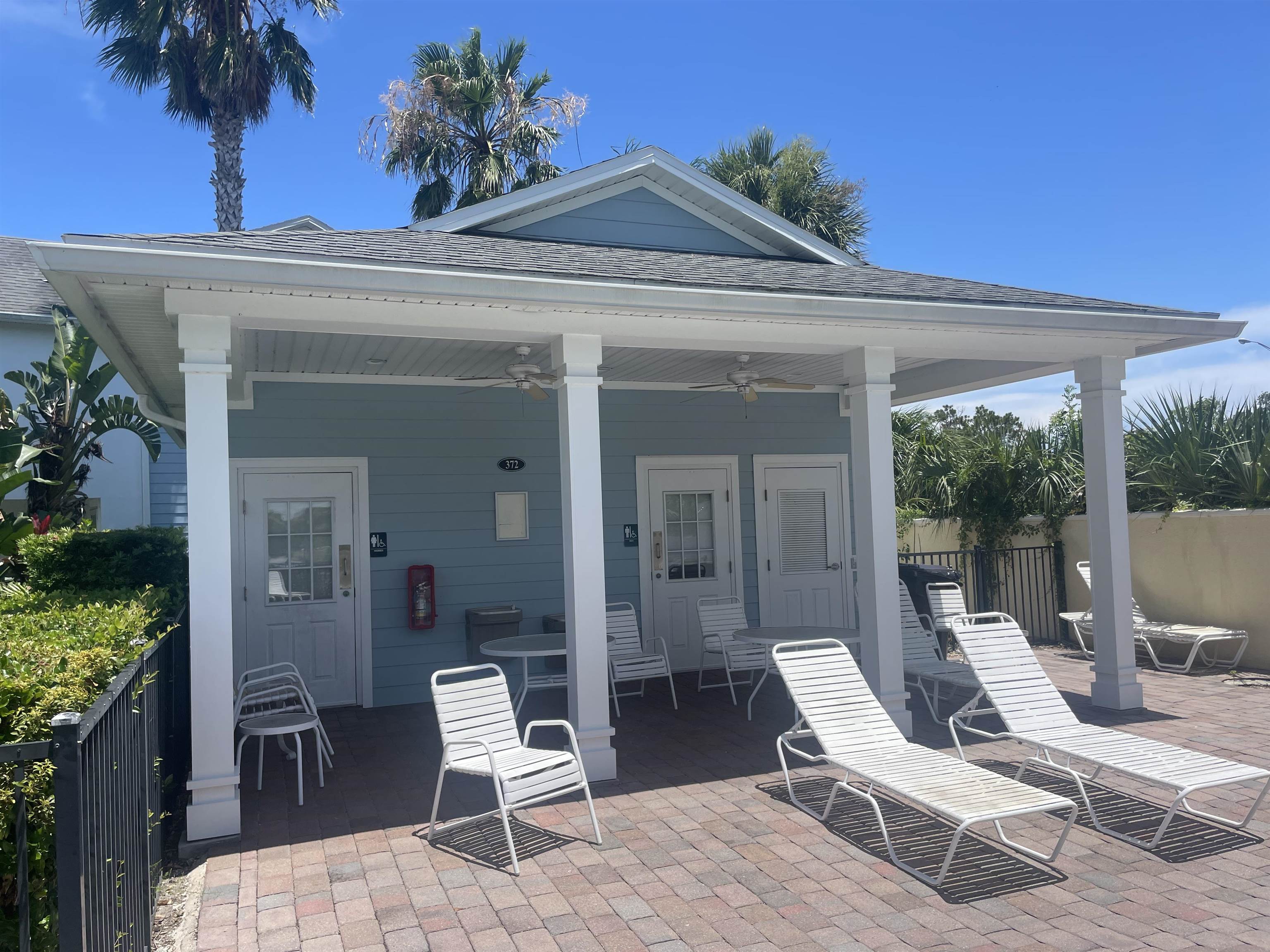 171 Islander Drive St. Augustine, FL 32080 - Photo 32 of 36 a view of a patio with a table and chairs and potted plants