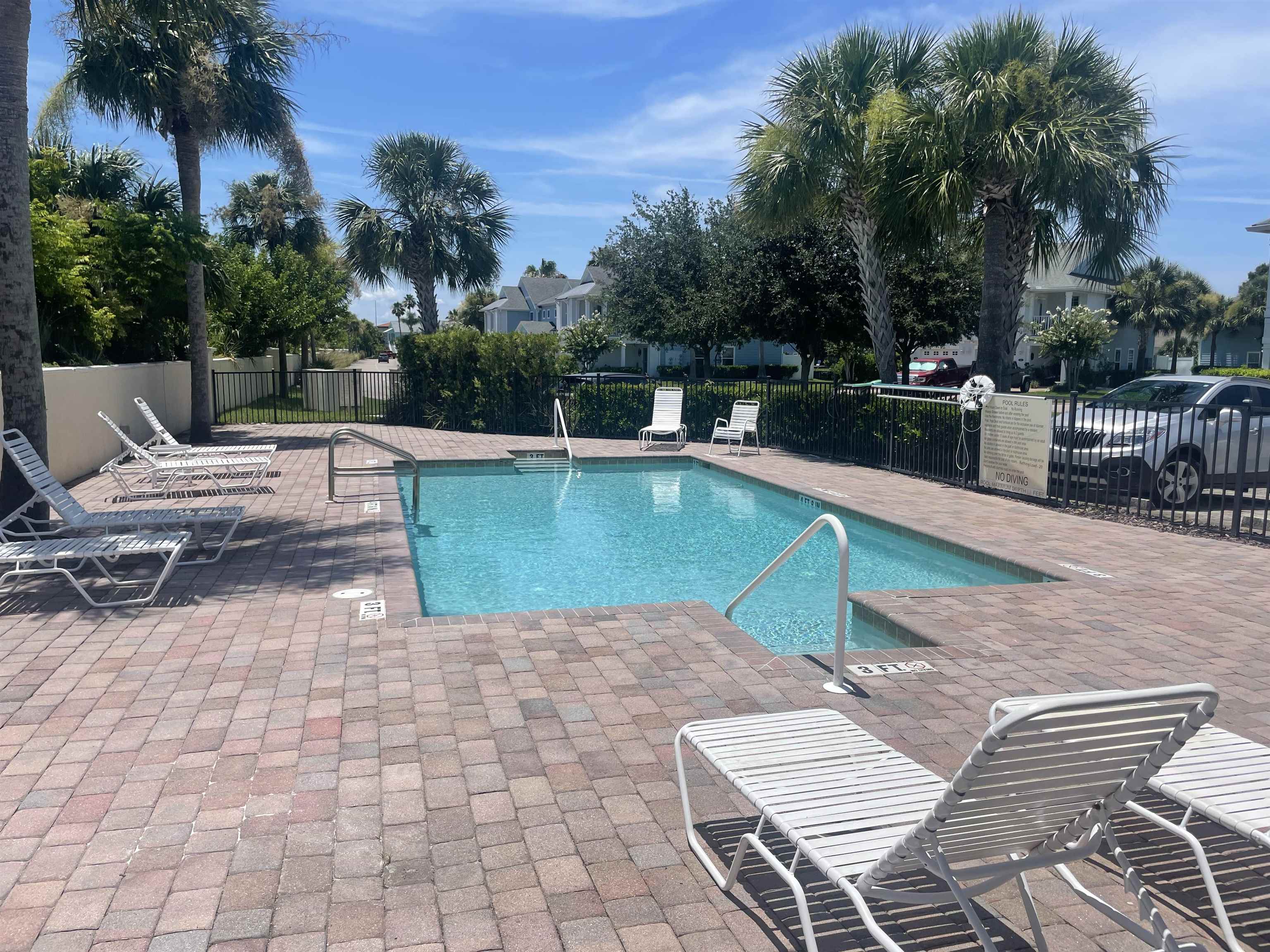 171 Islander Drive St. Augustine, FL 32080 - Photo 33 of 36 a view of a swimming pool with lounge chairs on th patio