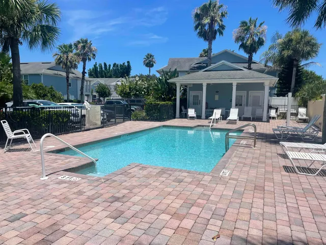 a view of a house with swimming pool and sitting area