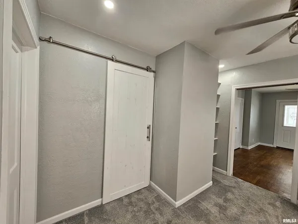 a view of a chandelier fan in a room