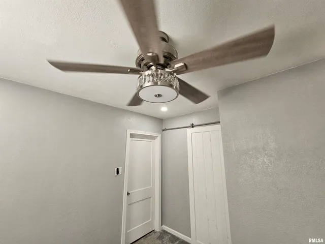 a view of an empty room with a cabinet