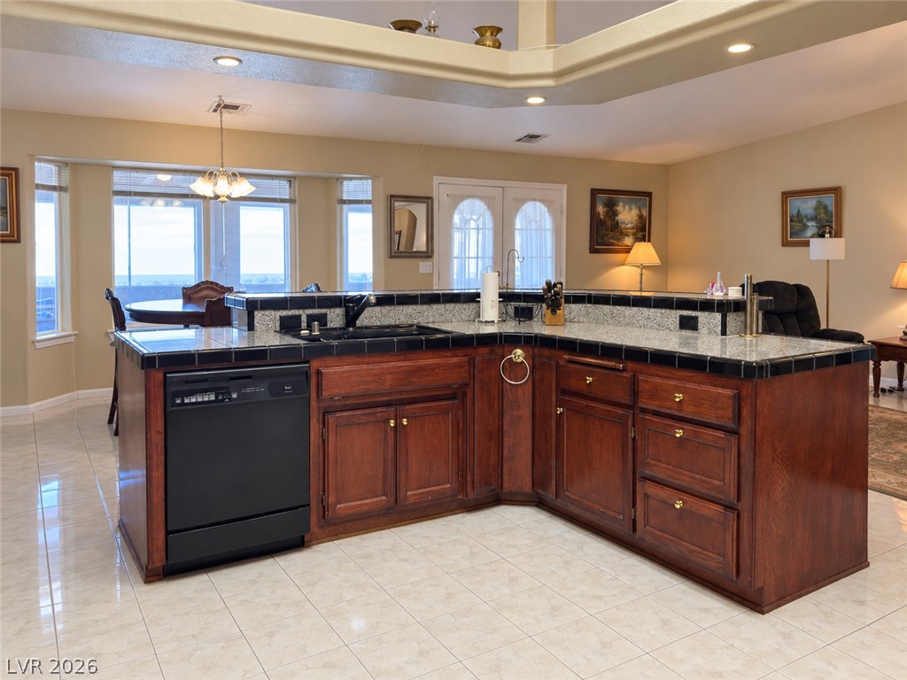 5470 Grain Mill Road Pahrump, NV 89061 - Photo 11 of 80 Gleaming tile floors anchor this central island kitchen complete with warm wood cabinetry and tiered countertops.