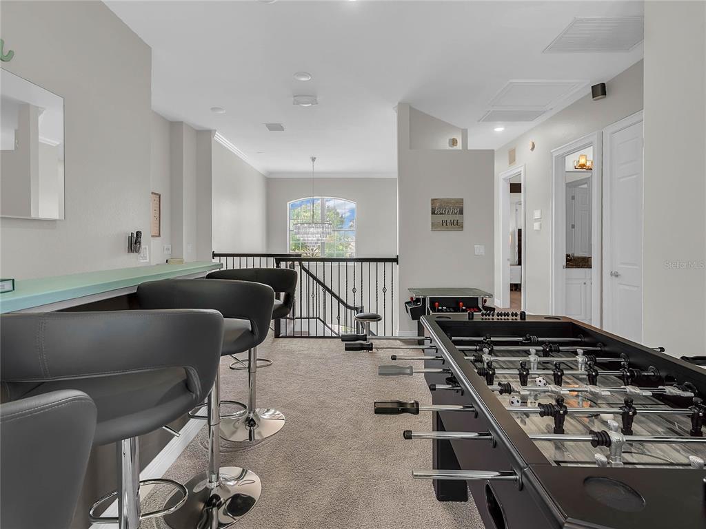 1231 Radiant Street Reunion, FL 34747 - Photo 22 of 26 a kitchen with a table chairs and a stove