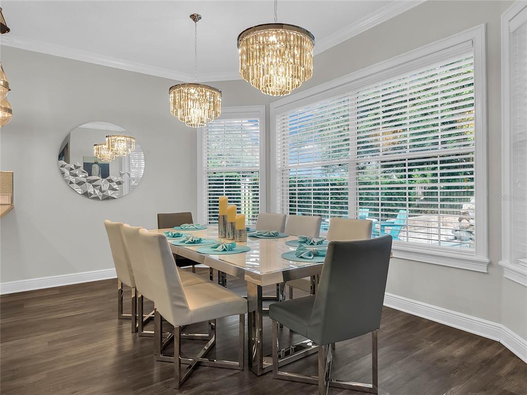 1231 Radiant Street Reunion, FL 34747 - Photo 4 of 26 a view of a dining room with furniture a chandelier and wooden floor