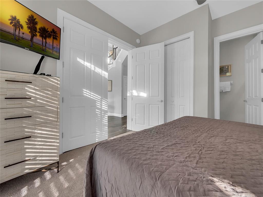 1231 Radiant Street Reunion, FL 34747 - Photo 8 of 26 a bedroom with a bed and a mirror