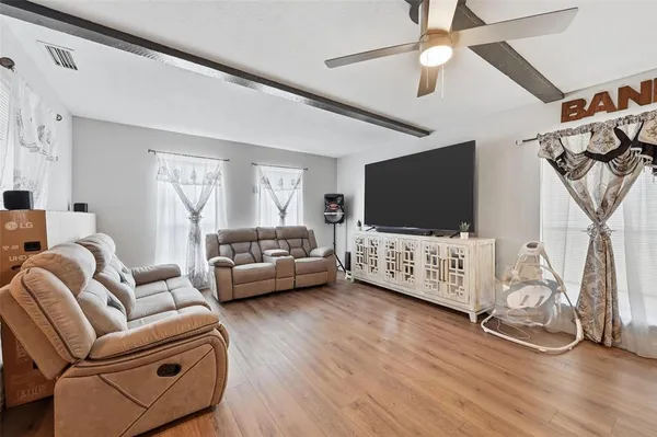a view of empty room with wooden floor and fireplace