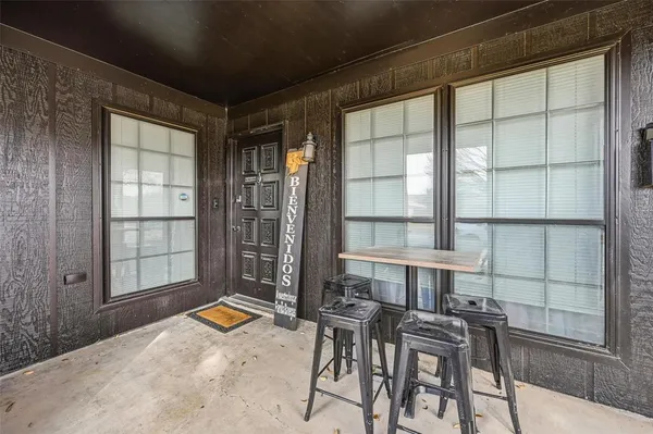 a view of a dining room with furniture and a window