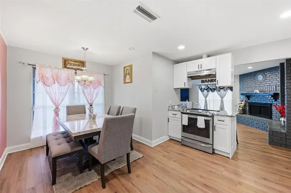 a view of a dining room with furniture kitchen and wooden floor