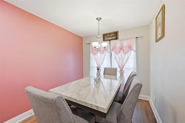 a view of a dining room with furniture and wooden floor