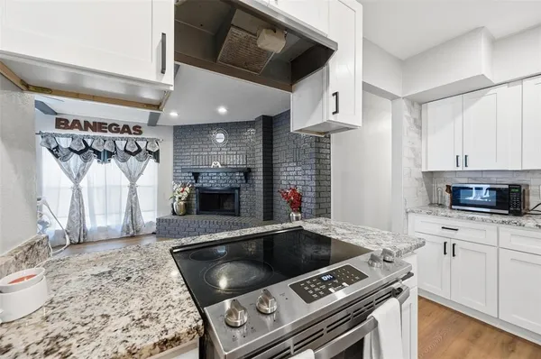 a kitchen with stainless steel appliances granite countertop a stove and a sink