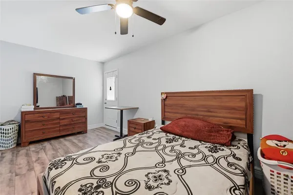 a bedroom with a bed window and a flat screen tv