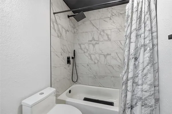 a bathroom with a shower and a toilet