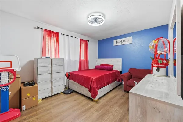 a bedroom with a bed and a dresser