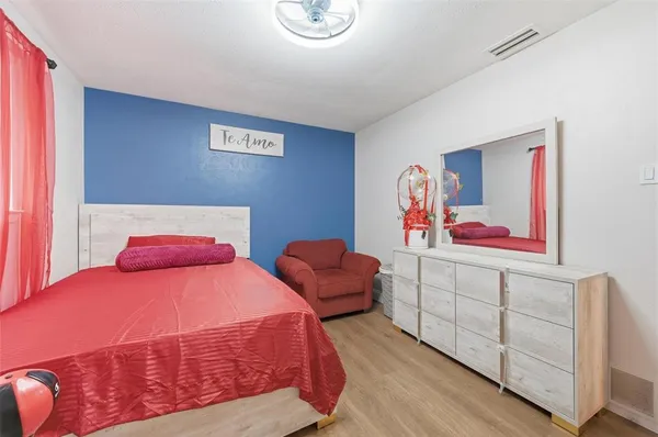 a bedroom with two beds and painting on the wall