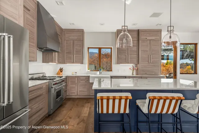 a living room with fireplace furniture and a large window