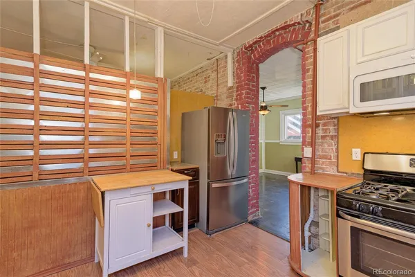 a kitchen with stainless steel appliances granite countertop a refrigerator and a stove