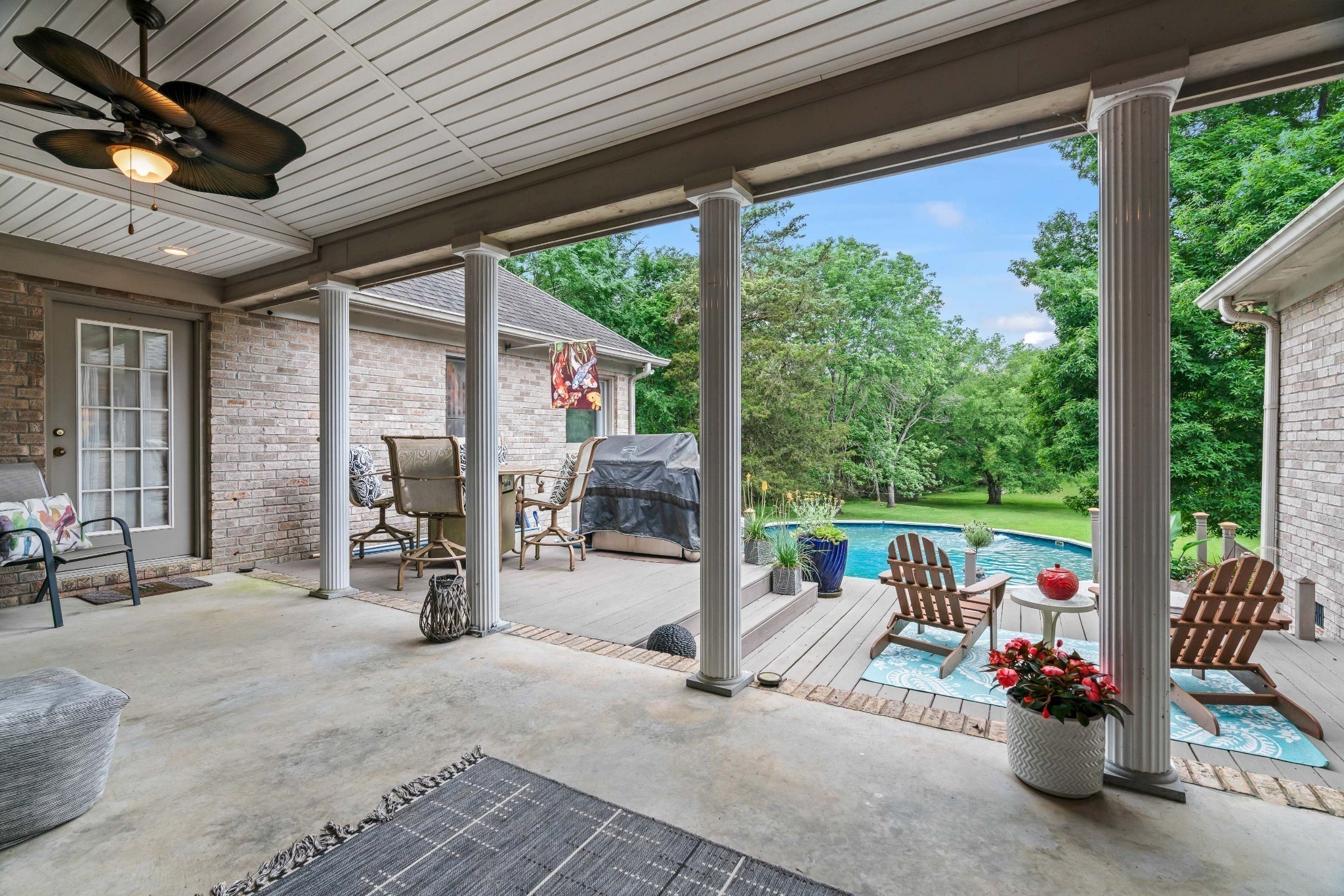 5544 South New Hope Road Hermitage, TN 37076 - Photo 39 of 62 a view of a patio with a table chairs and a floor to ceiling window with wooden fence