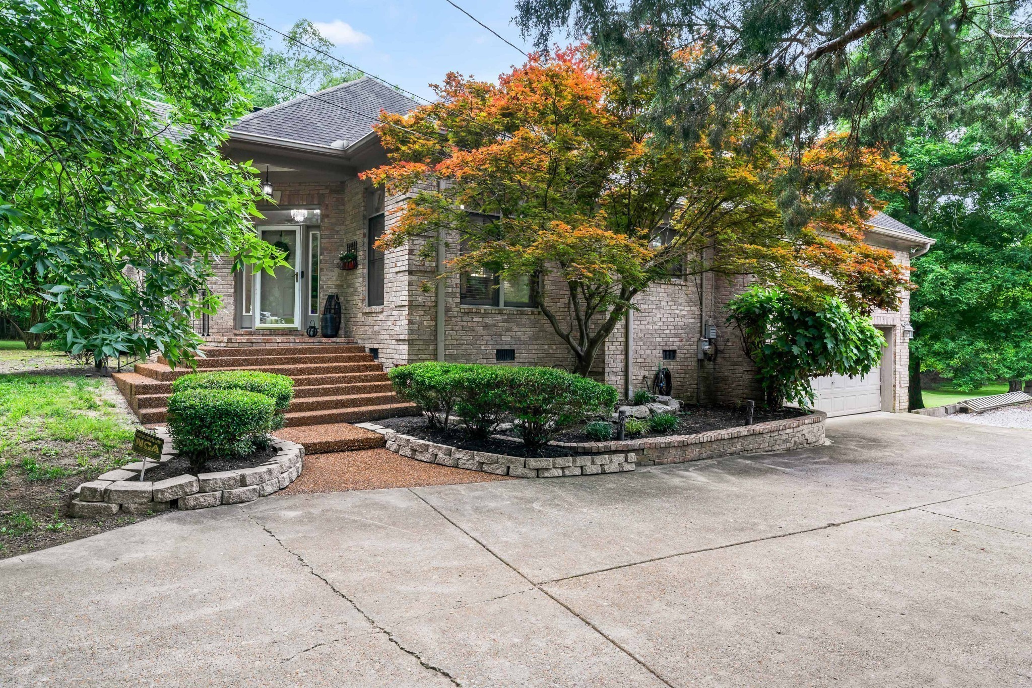 5544 South New Hope Road Hermitage, TN 37076 - Photo 45 of 62 a view of a house with potted plants and a bench