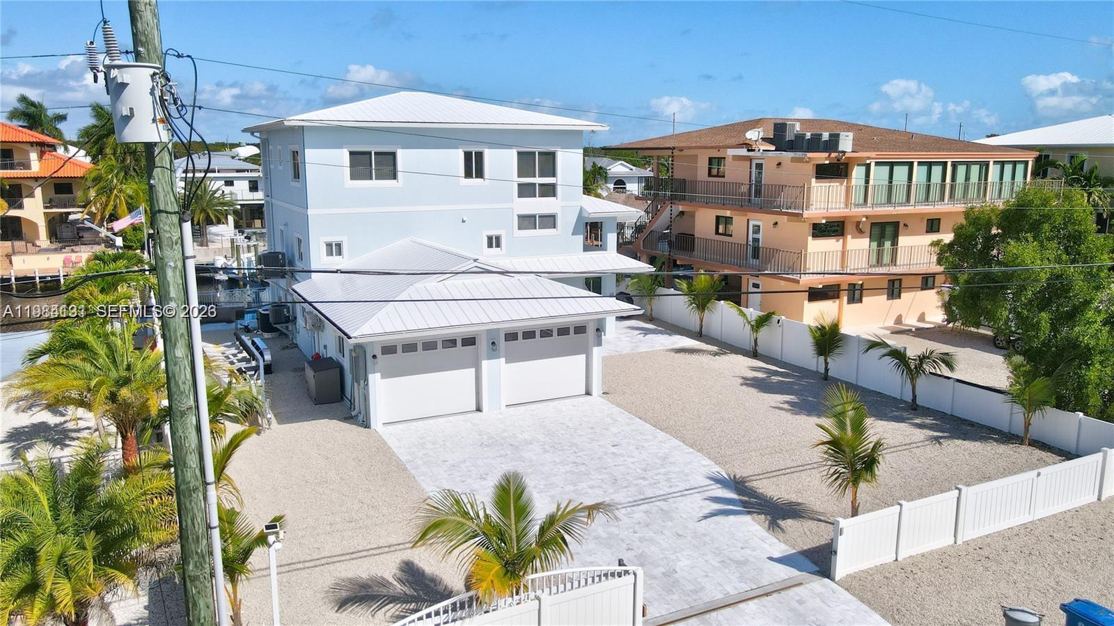 48 Andros Road Key Largo, FL 33037 - Photo 2 of 59 a front view of a house with a yard