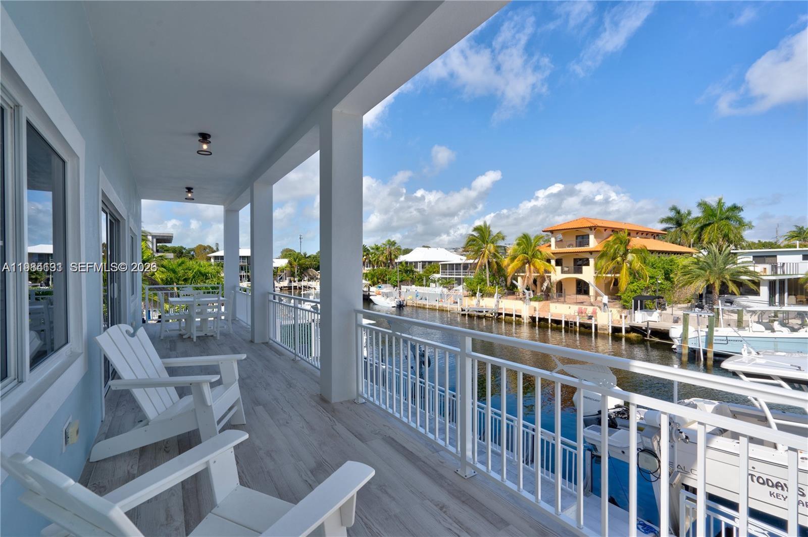48 Andros Road Key Largo, FL 33037 - Photo 30 of 59 a view of a balcony with chairs