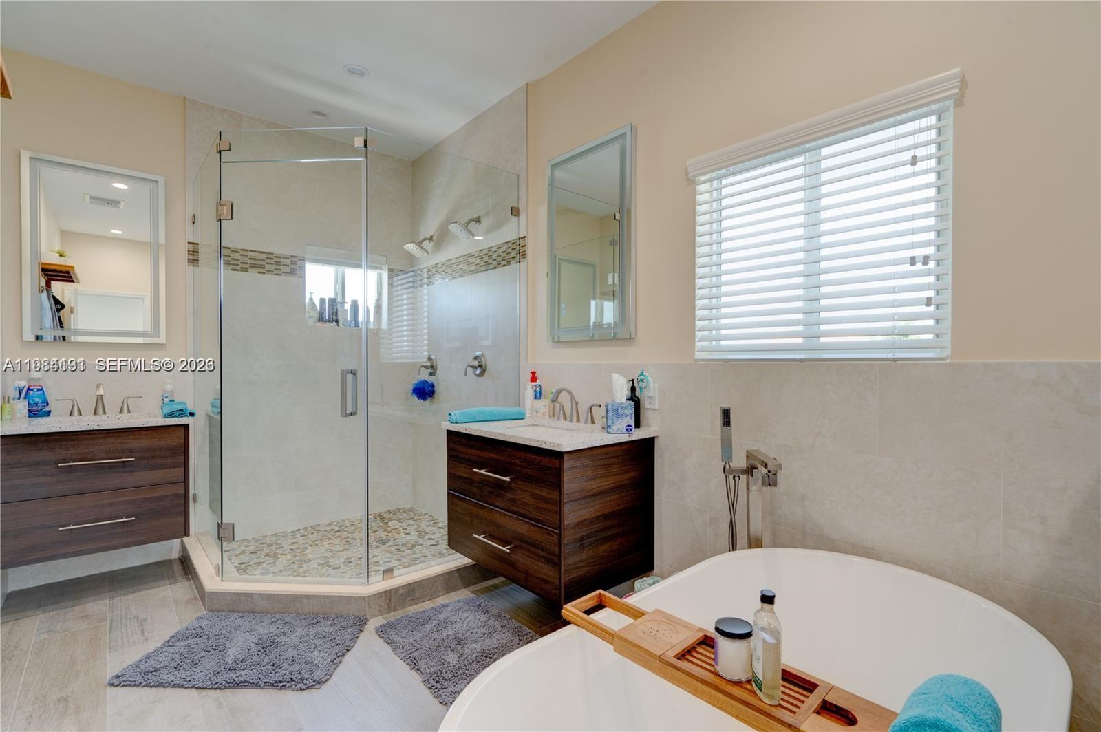 48 Andros Road Key Largo, FL 33037 - Photo 40 of 59 a bathroom with a tub sink and mirror
