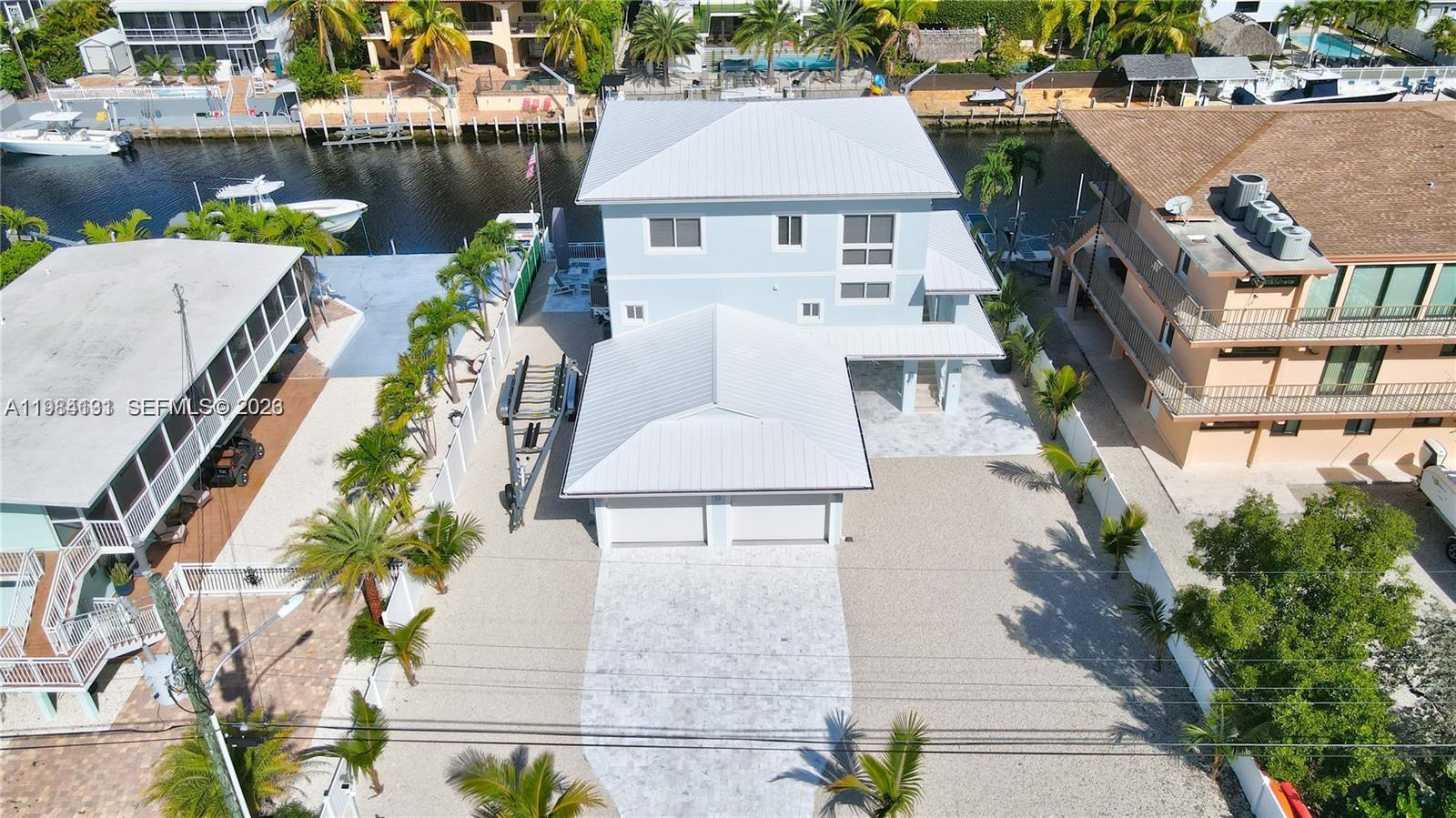 48 Andros Road Key Largo, FL 33037 - Photo 4 of 59 an aerial view of a house with a garden and plants