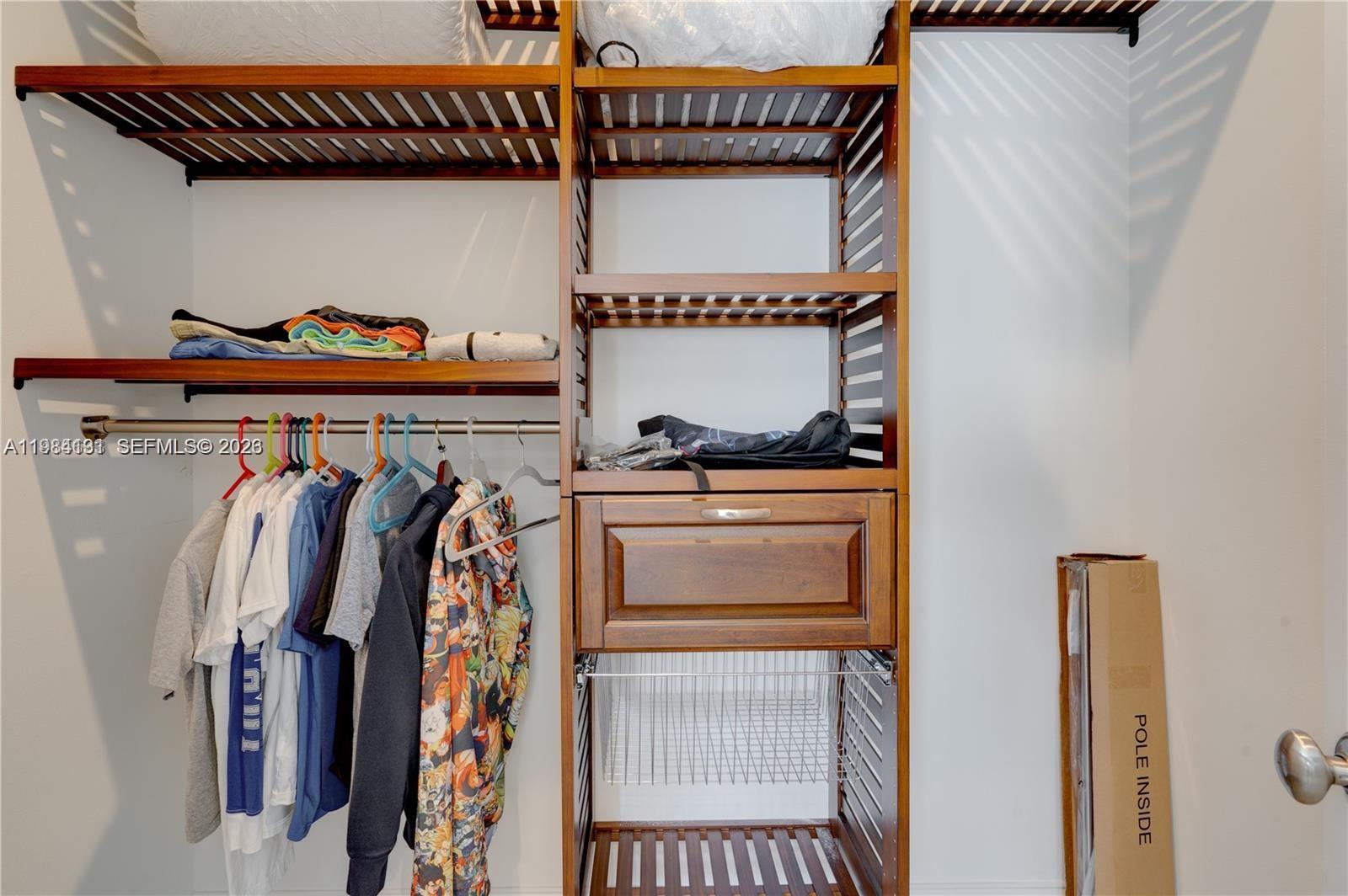 48 Andros Road Key Largo, FL 33037 - Photo 52 of 59 a view of walk in closet with clothes and shoes