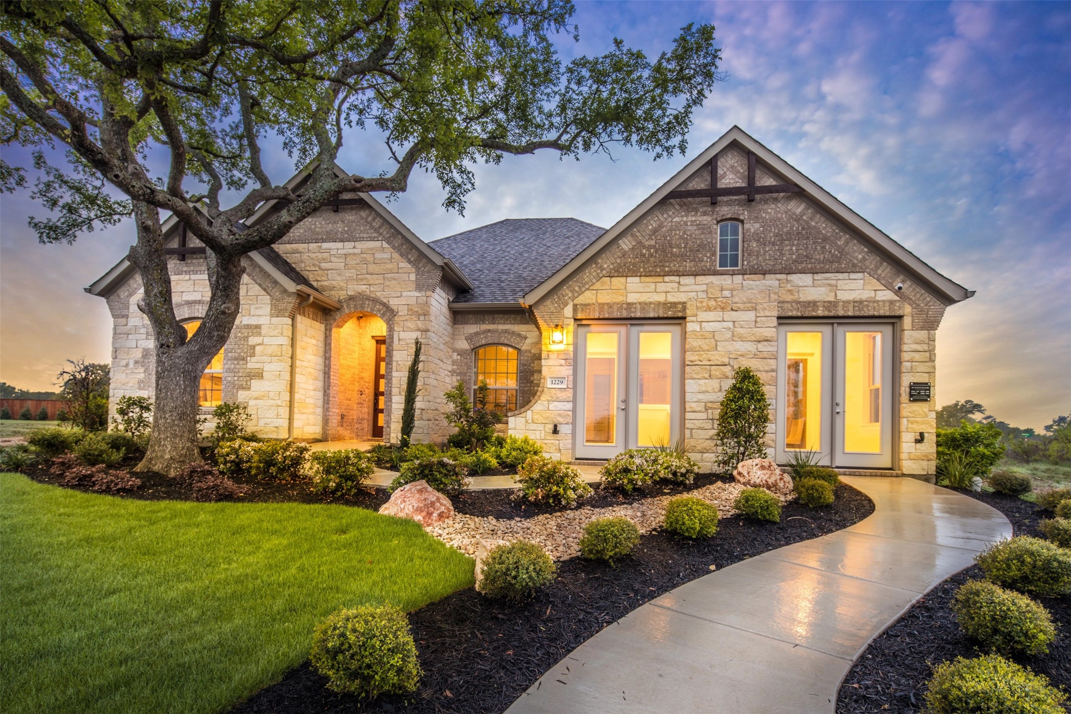 1229 Terrace View Drive Georgetown, TX 78628 - Photo 2 of 17 A graceful curved walkway guides visitors to the inviting entrance of this elegant stone-clad residence.