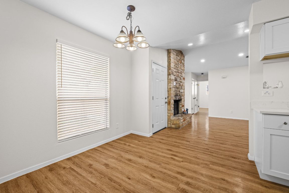 12801 Copper Cliff Avenue, Unit B Austin, TX 78727 - Photo 11 of 23 a view of livingroom with kitchen island furniture and wooden floor
