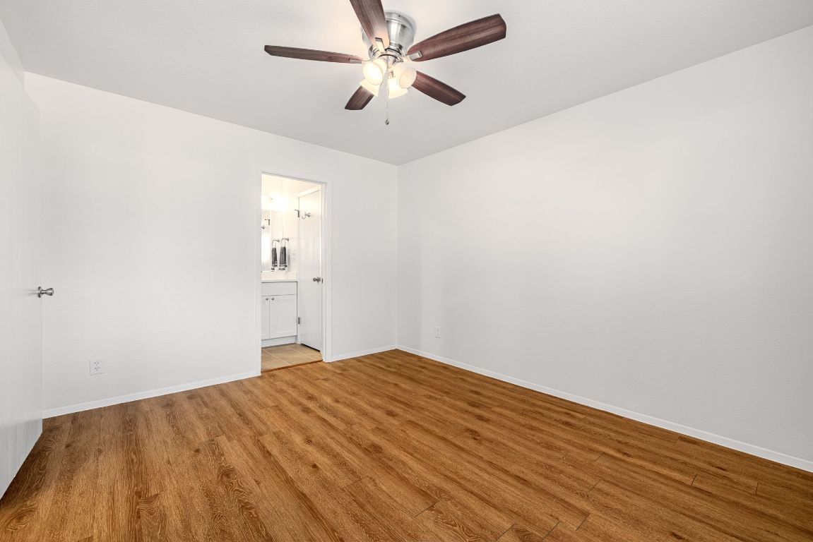 12801 Copper Cliff Avenue, Unit B Austin, TX 78727 - Photo 12 of 23 a view of empty room with wooden floor