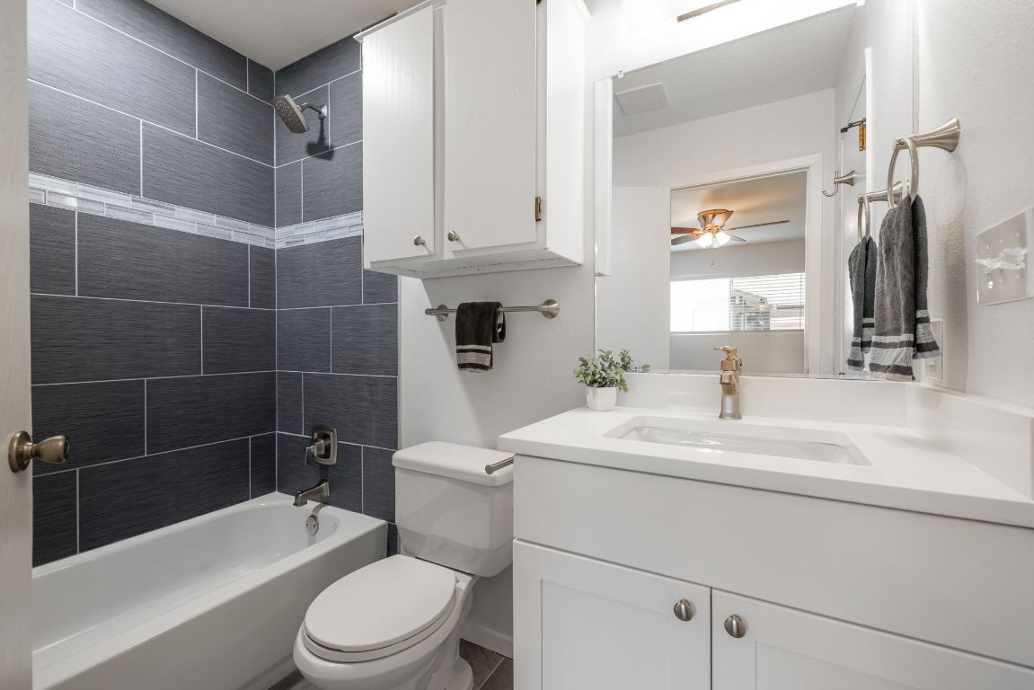 12801 Copper Cliff Avenue, Unit B Austin, TX 78727 - Photo 15 of 23 a bathroom with a sink a toilet and shower