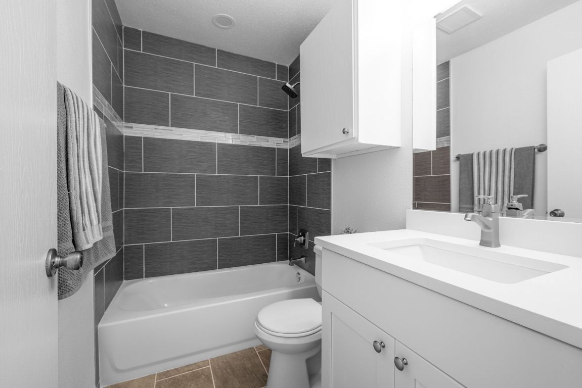 12801 Copper Cliff Avenue, Unit B Austin, TX 78727 - Photo 17 of 23 a bathroom with a sink a toilet and a bathtub