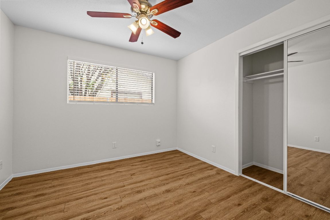 12801 Copper Cliff Avenue, Unit B Austin, TX 78727 - Photo 18 of 23 a view of an empty room with wooden floor and a window