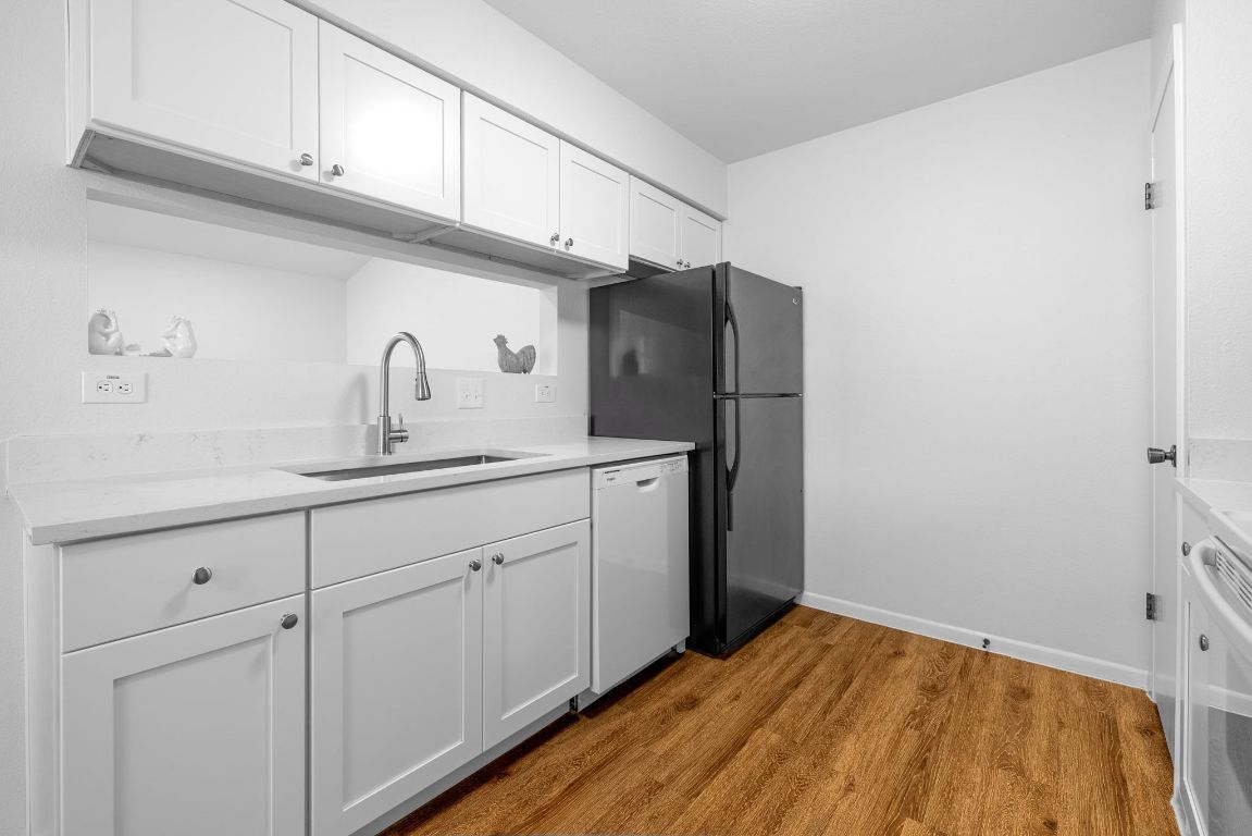 12801 Copper Cliff Avenue, Unit B Austin, TX 78727 - Photo 8 of 23 a kitchen with cabinets and stainless steel appliances