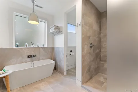 a bathroom with a double vanity sink mirror and shower