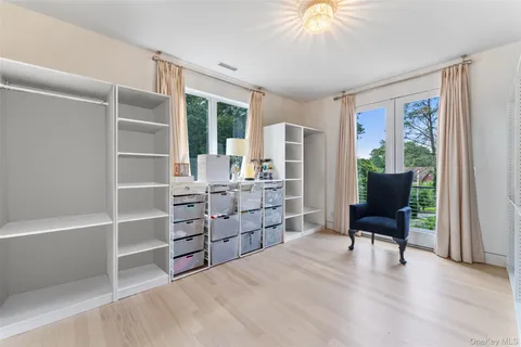 a view of a balcony with chair and wooden floor
