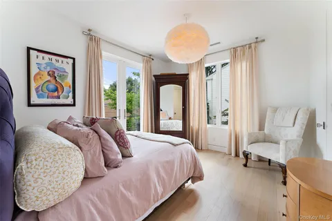 a bathroom with a sink a toilet a mirror and shower