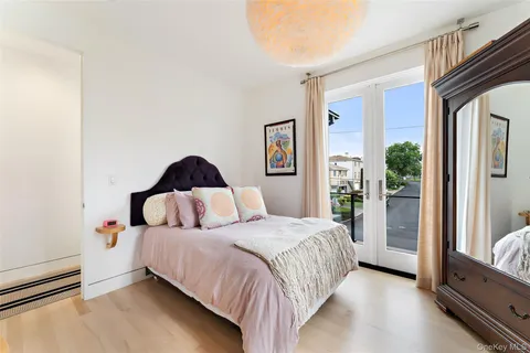 a bed room with a bed and a painting on the wall