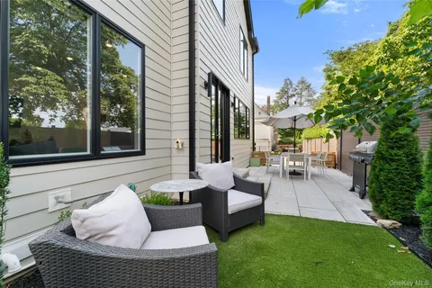 a spacious bathroom with a double vanity sink a toilet and a mirror