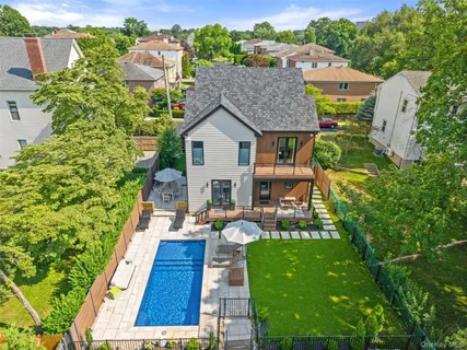 a view of house with swimming pool outdoor seating