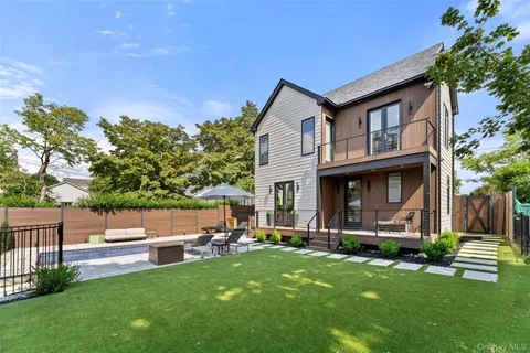 a view of a house with a yard patio and a garden