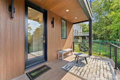 a view of an house with backyard and a tree