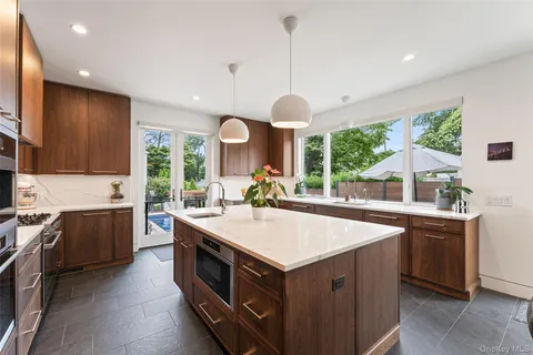 a kitchen with a sink stove and wooden cabinets