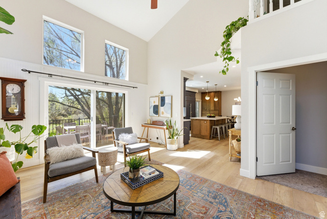 7935 Mustang Loop Road Park City, UT 84098 - Photo 12 of 60 Spacious living area featuring a vaulted ceiling with light wood-finish flooring, white walls, and a sliding glass door leading to an outdoor deck