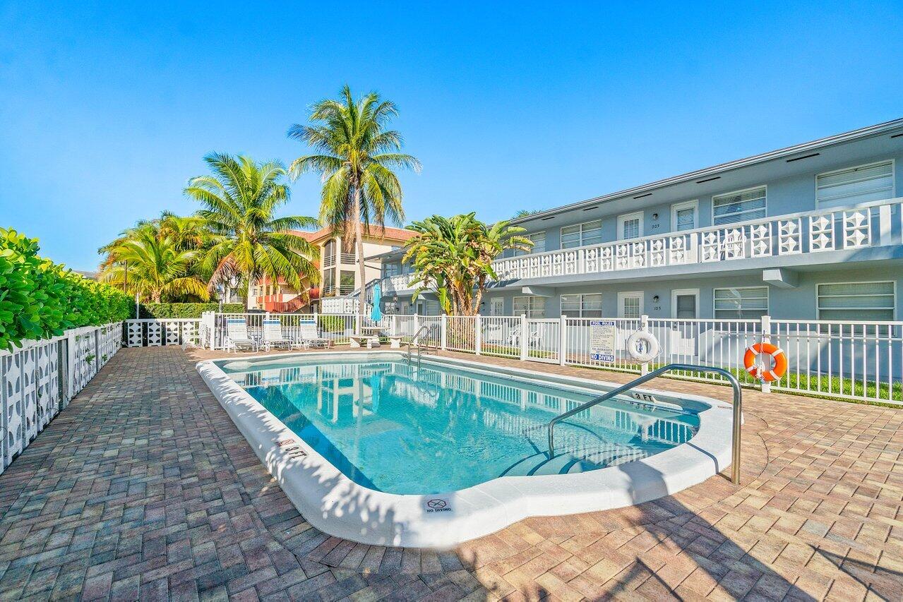 a swimming pool with outdoor seating and yard