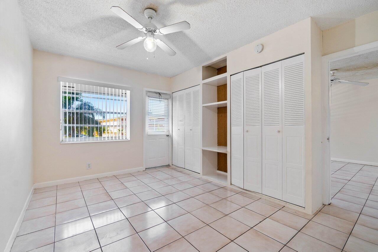 701 Pine Drive, Unit 210 Pompano Beach, FL 33060 - Photo 12 of 20 a view of an empty room with window and chandelier fan