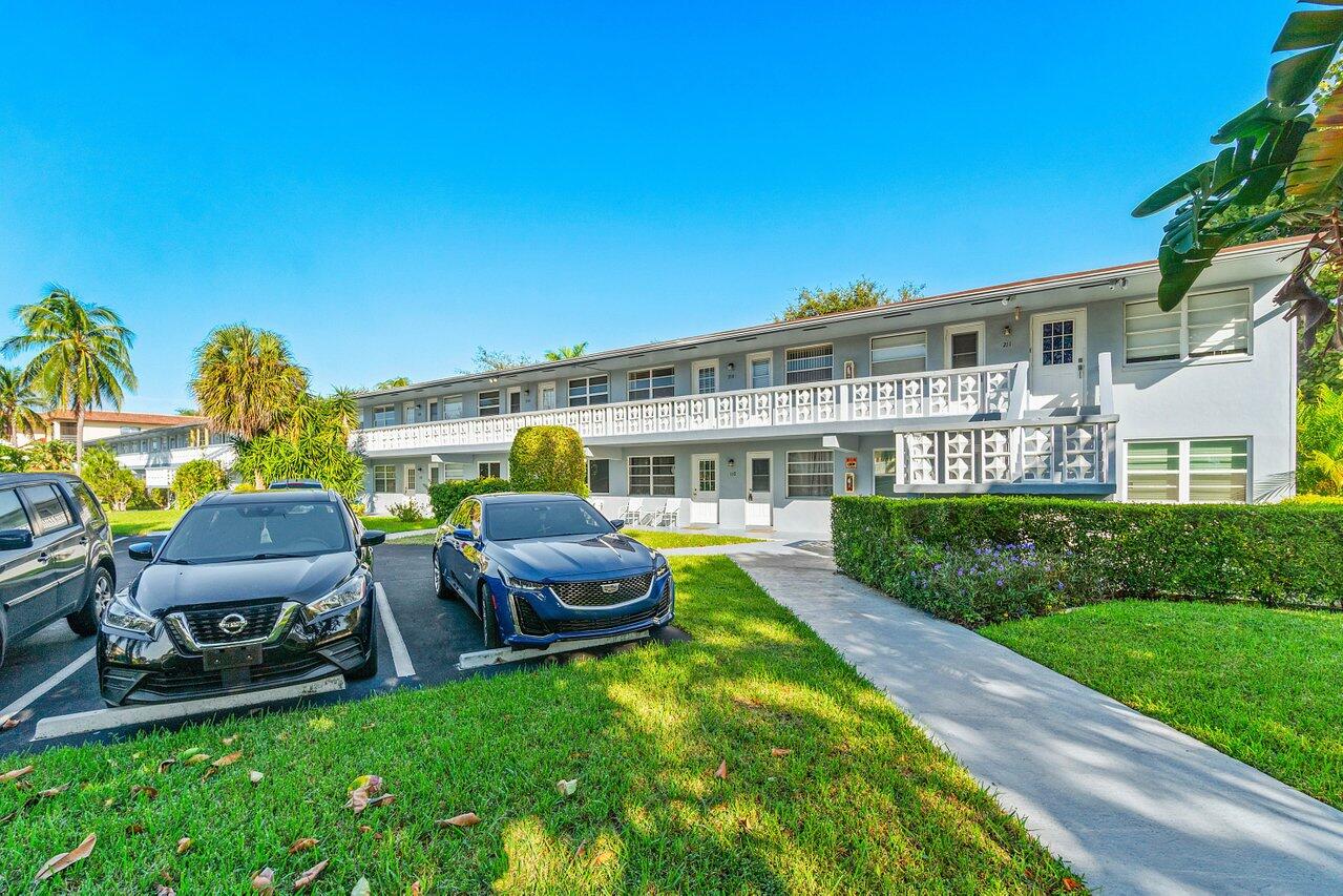 701 Pine Drive, Unit 210 Pompano Beach, FL 33060 - Photo 20 of 20 a view of a patio with table and chairs potted plants and palm tree