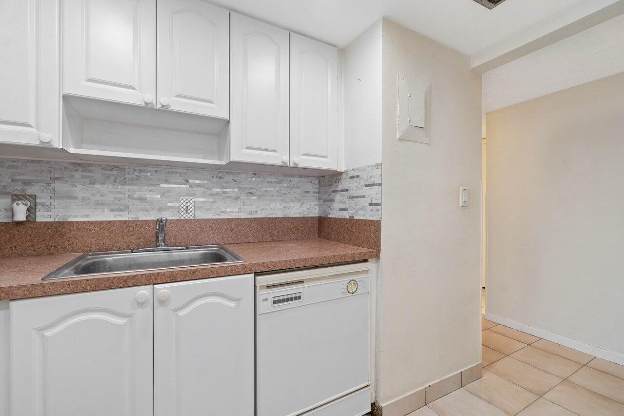 701 Pine Drive, Unit 210 Pompano Beach, FL 33060 - Photo 3 of 20 a kitchen with a sink and cabinets