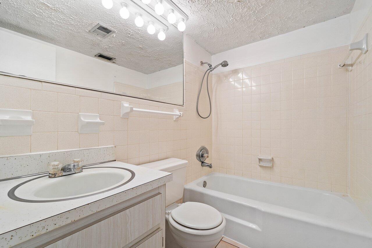 701 Pine Drive, Unit 210 Pompano Beach, FL 33060 - Photo 8 of 20 a bathroom with a sink toilet vanity and shower